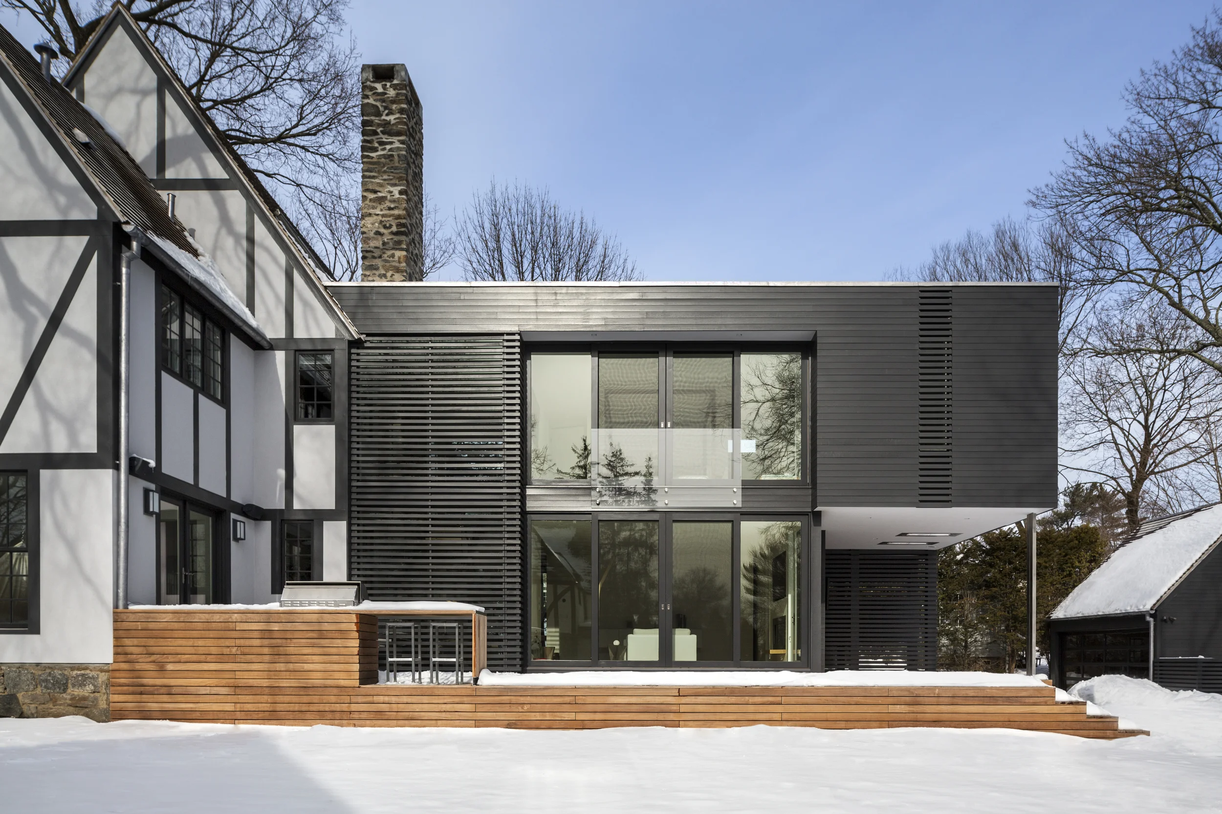 Oddly compatible modern addition on traditional house