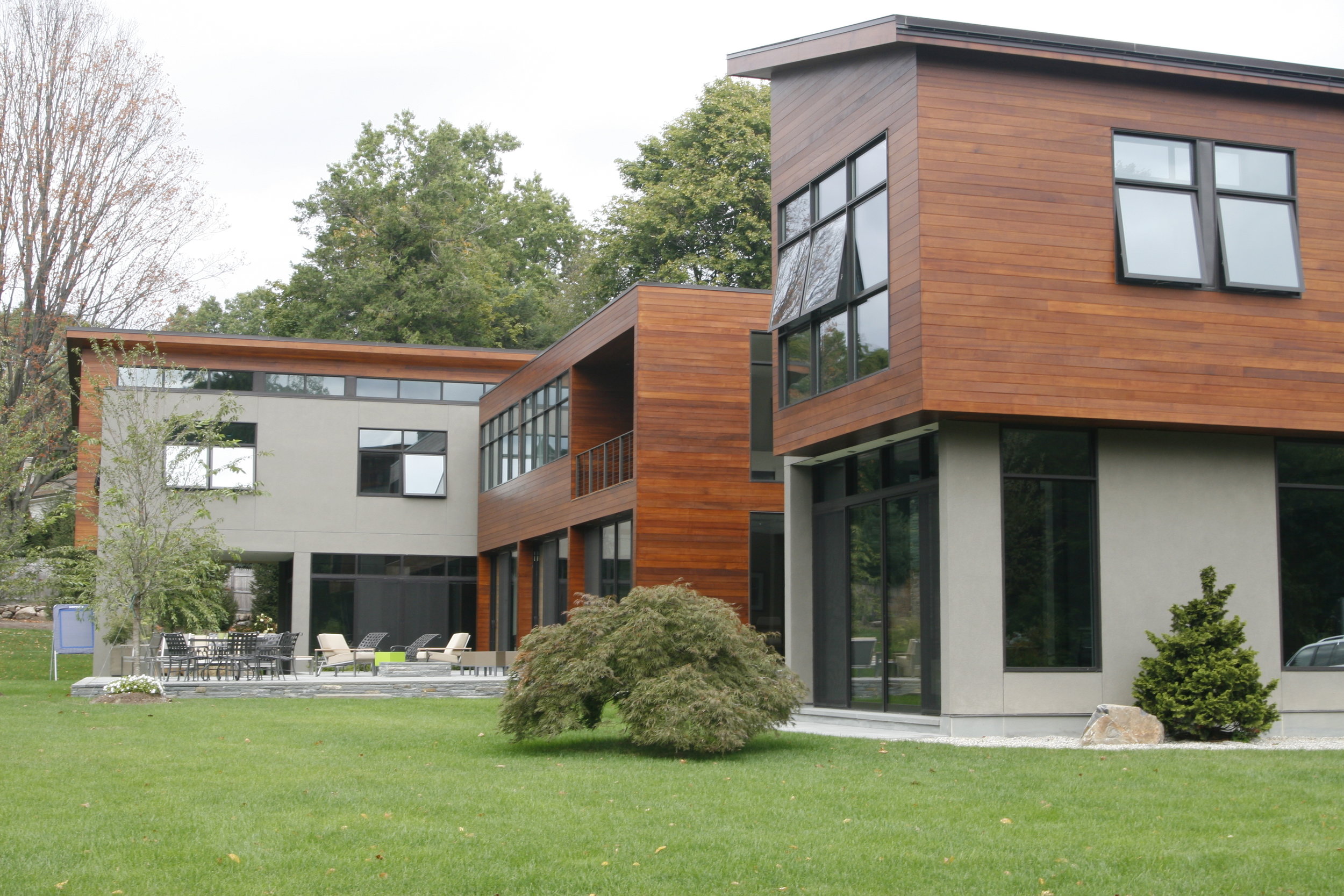 modern architecture stone and wood siding landscaping