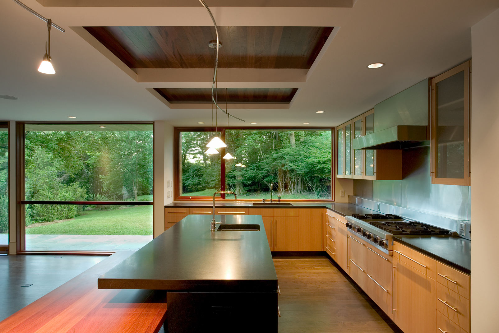 super clean modern kitchen bright large glass windows 