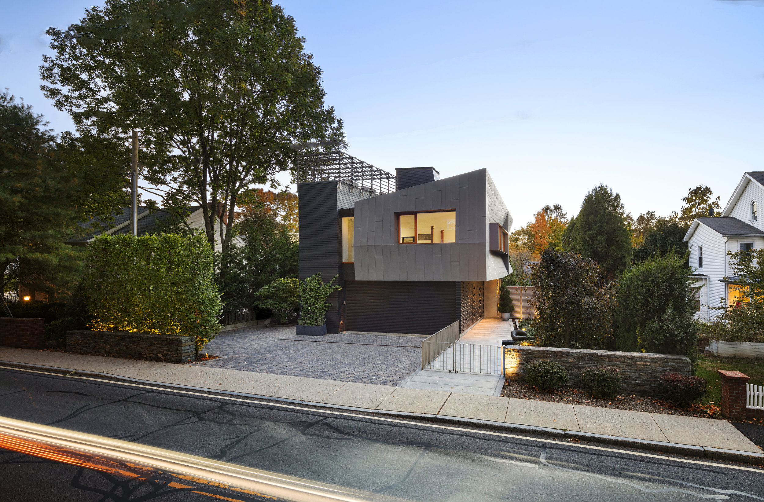 new canaan townhouse during sunset with a rooftop terrace