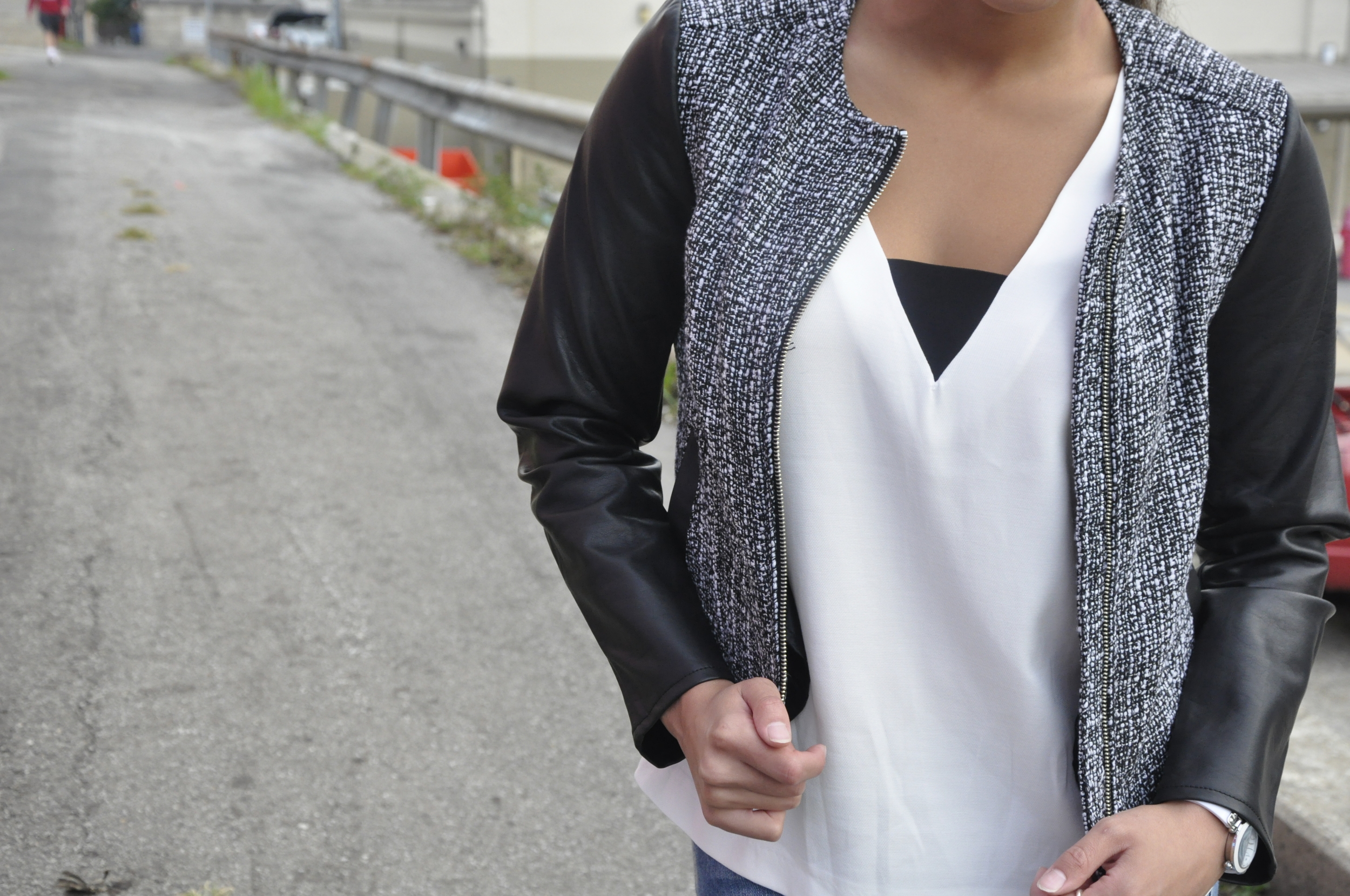 This top is a staple in my wardrobe! It's can be casual, it can be dressy, but most importantly, it is versatile. It's black and white, so you can wear it with many different color and style bottoms. The V-neck paired with the contrasting horizontal black fabric adds a modern edge, which compliments the jackets modern look. 