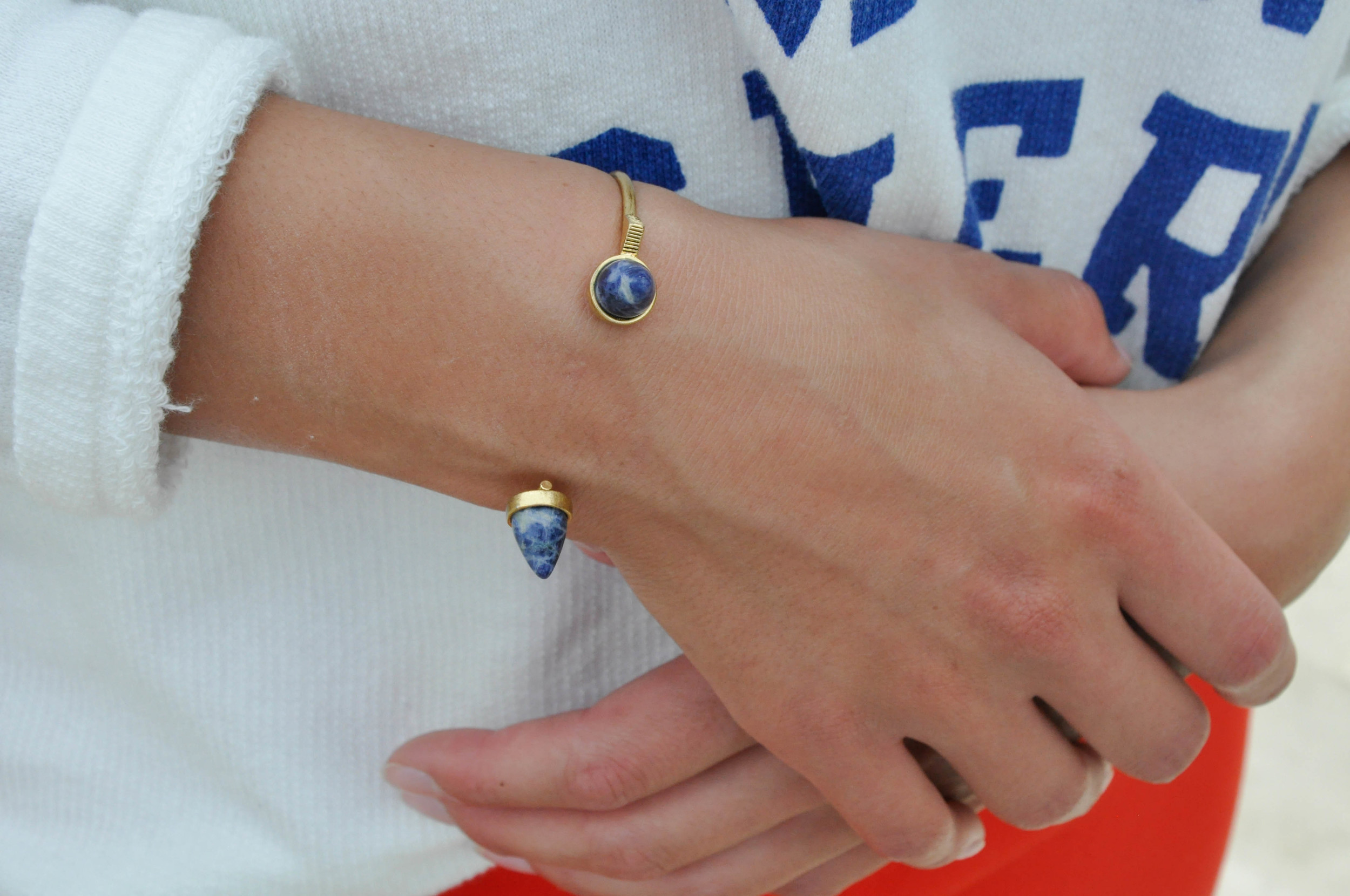 Madewell has created a great line of jewelry that is effectively different as well as unique (just like this bracelet). They carry many different shapes and colors that help build a great outfit! The bright blue writing on the sweater compliments the blue marble stone on the bracelet. This style of bracelet that does not completely close is one that more and more brands are starting to pick up on. 