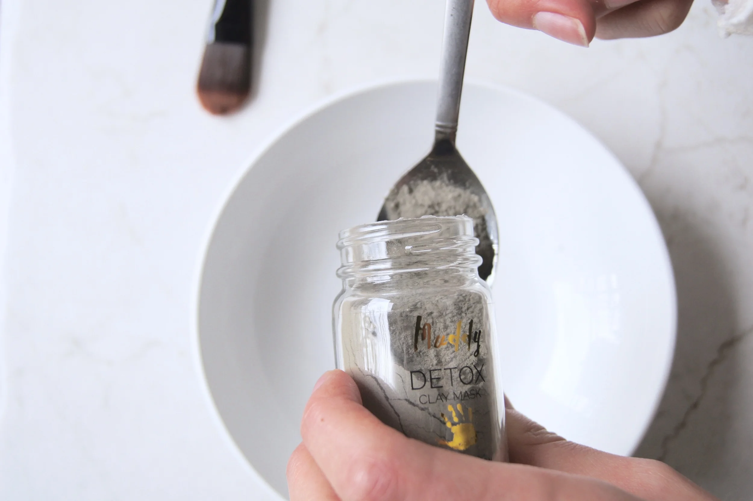 Pour a spoonful of your mask mix into your small bowl. It's ok if this looks like more than what you need for your face. I used the excess mask I had and put it on the tops of my hands! 