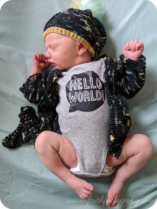 Sweater: Newborn Vertebrae Hat: Barley Light Pompom: Fffabuknits Socks: Baby Mitten Socks Yarn: Yarn vs Zombies, Cascade Heritage Sock