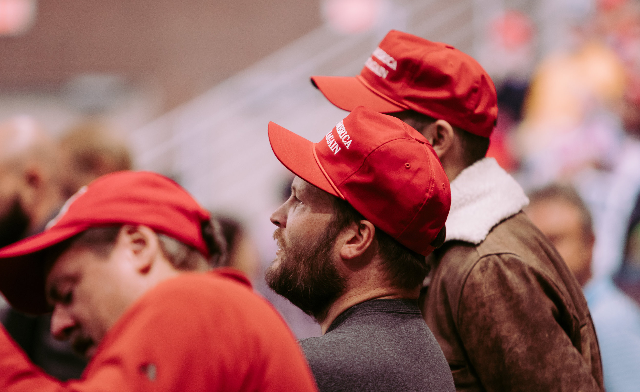 Supporters look on as President Trump speaks to a crowd at the Mayo Civic Center