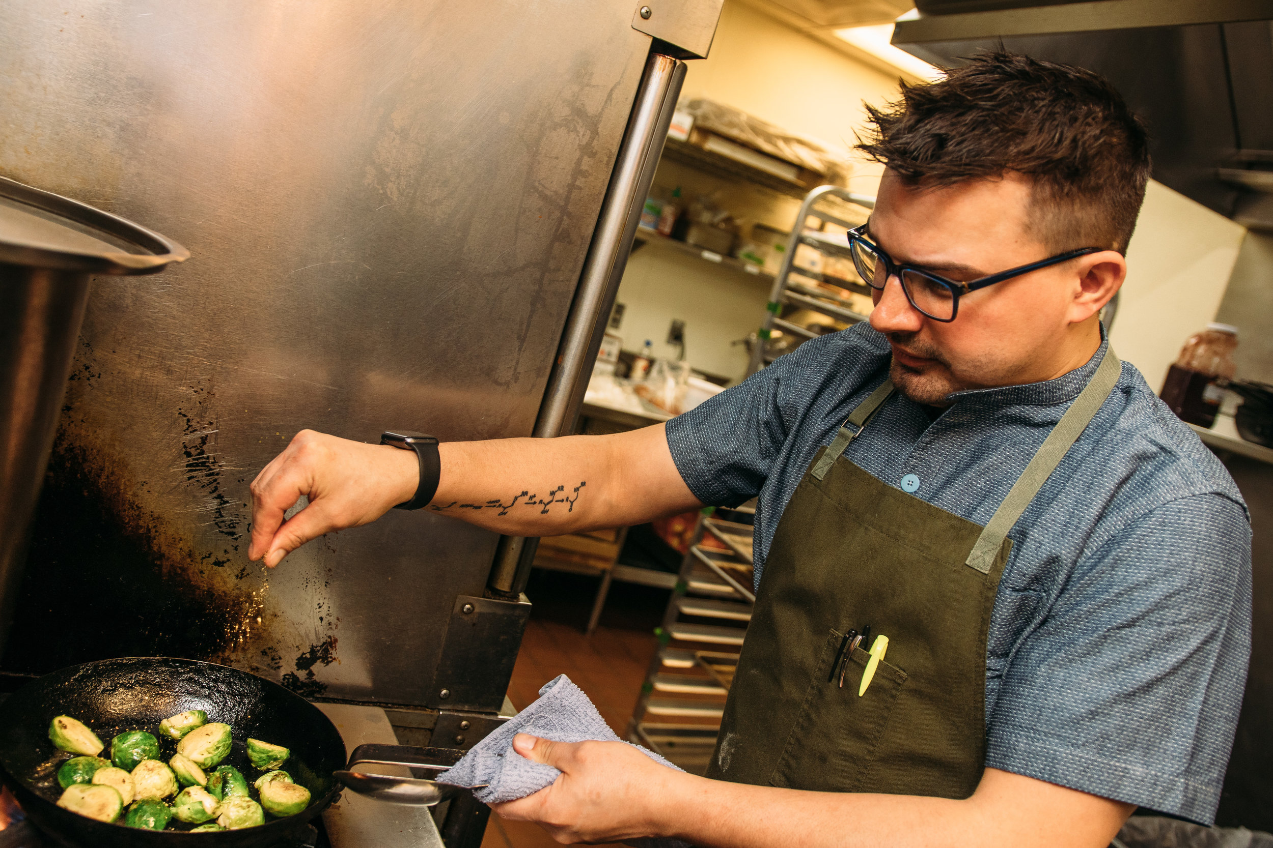 Justin cooks up the Brussels Sprouts, among the many sides featured on the menu. Porch also serves up smoked meats, all prepared in-house. Photography by William Forsman.