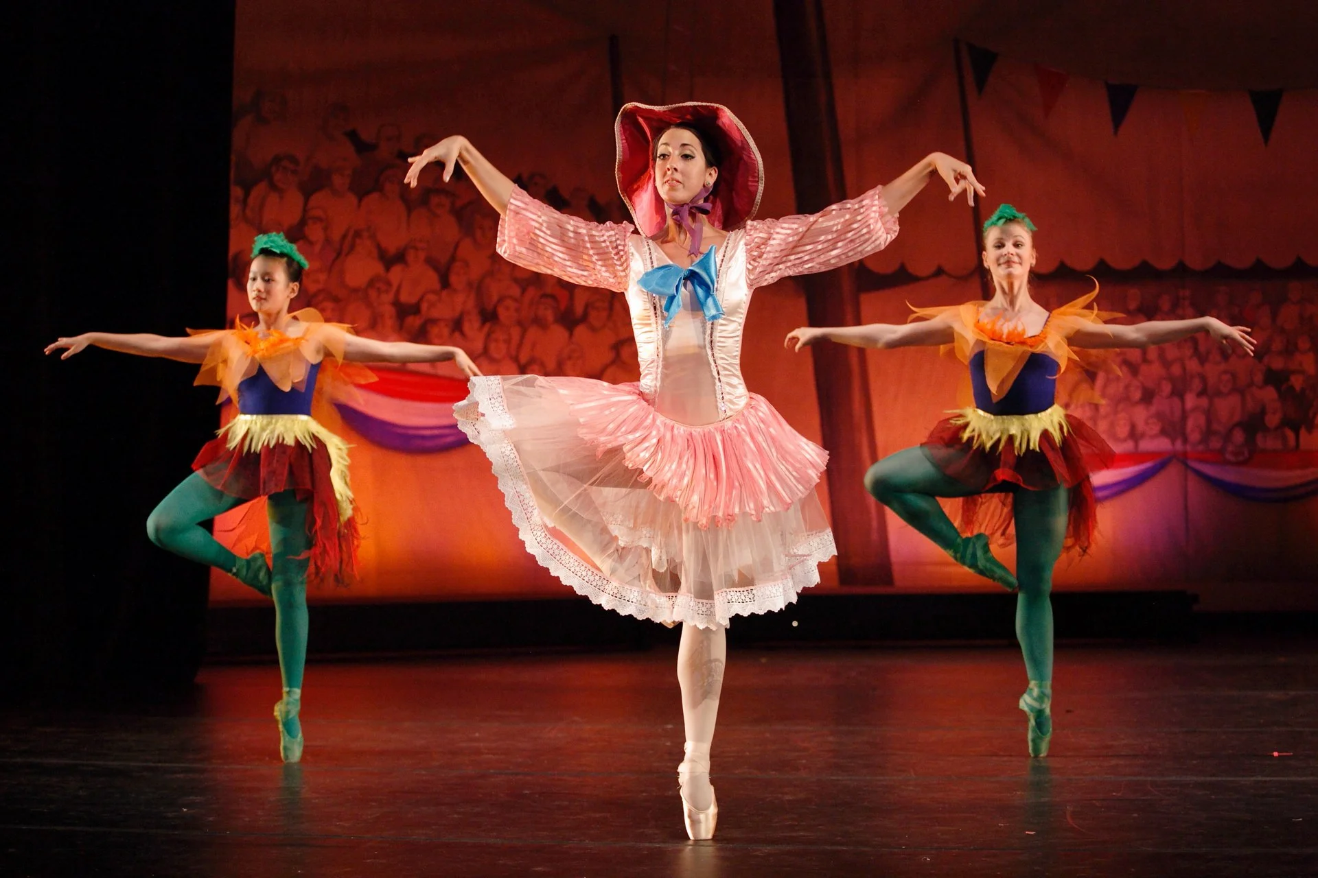 Simple backdrops used in a dance show still give a sense of place along with costumes.