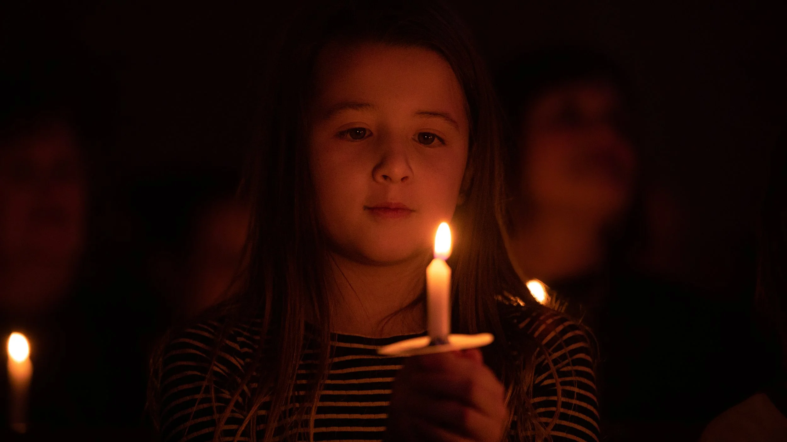  High-Quality Photograph: Young Girl Staring at Flame During Christmas Eve Candlelight Vigil Service 