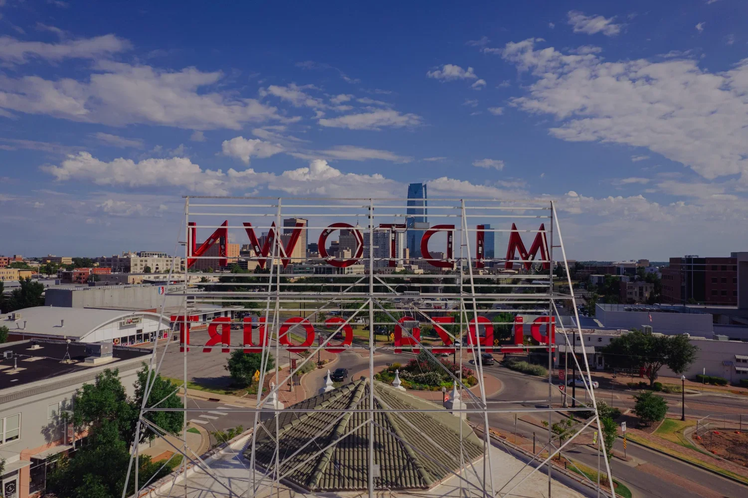 drone-architecture-okc-midtown-sign-behind-skyline.webp