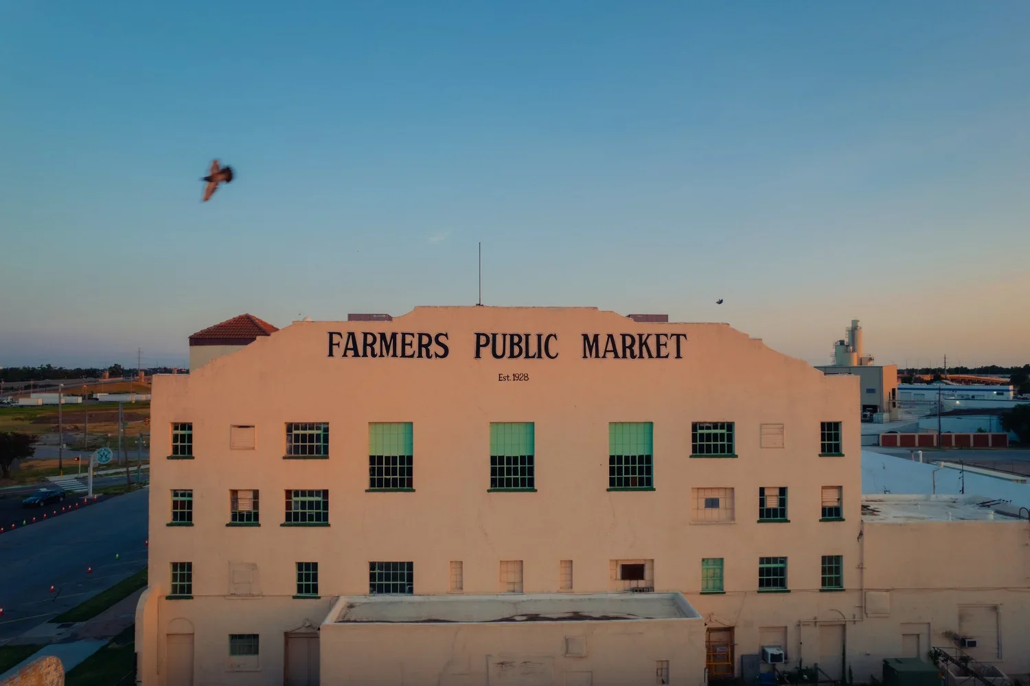 drone-okc-sunset-farmers-market-bird-passing.webp