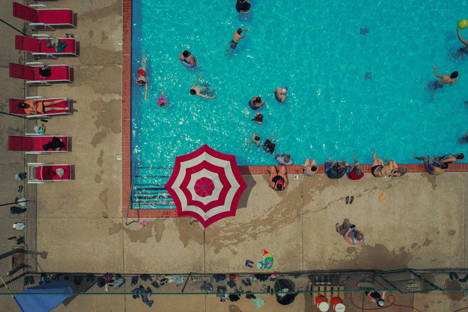 top-down-aerial-drone-outdoor-public-pool-hot-summer-day.webp