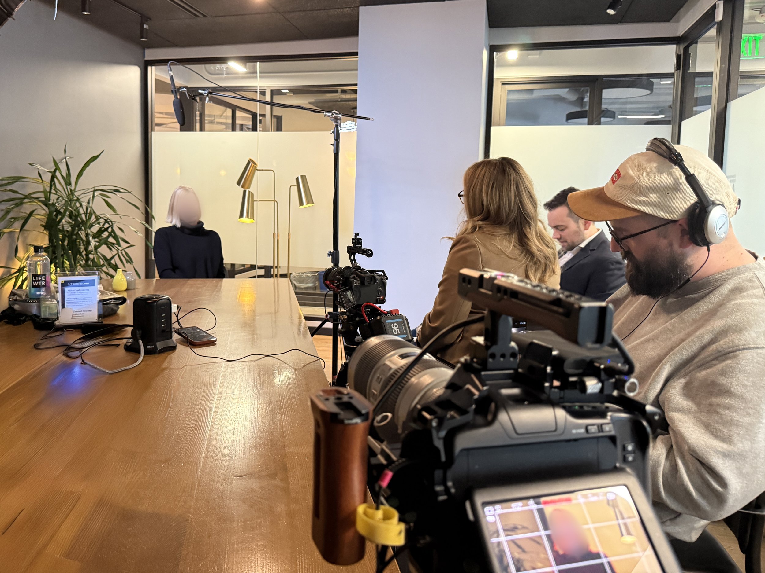 bts photo of videographer zach lucero recording 2 camera interview of client testimonial