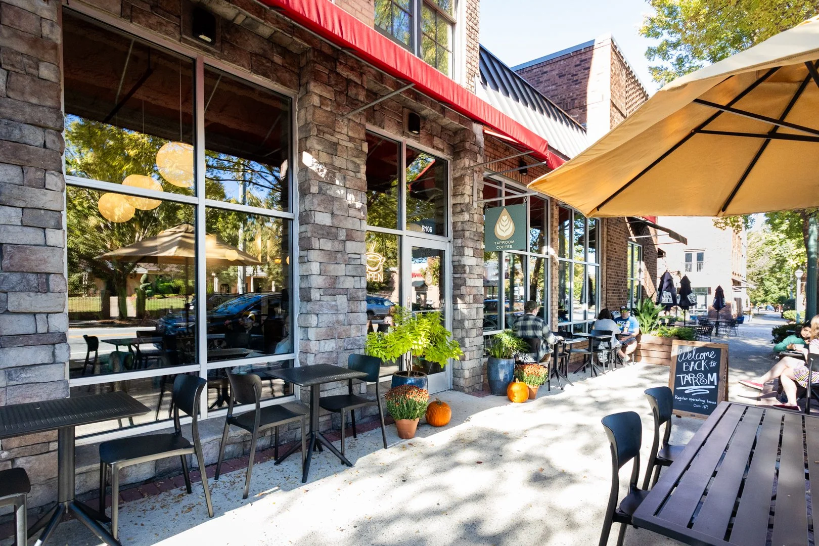 Building exterior with patio furniture and Taproom sign visible