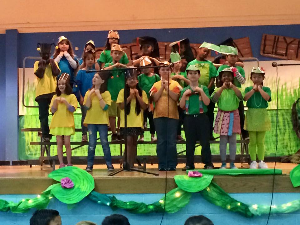Madeline is in the front row, second from the left. You know, the one straining her neck and voice and lungs. This surprises nobody. She is clearly FEELING IT. 