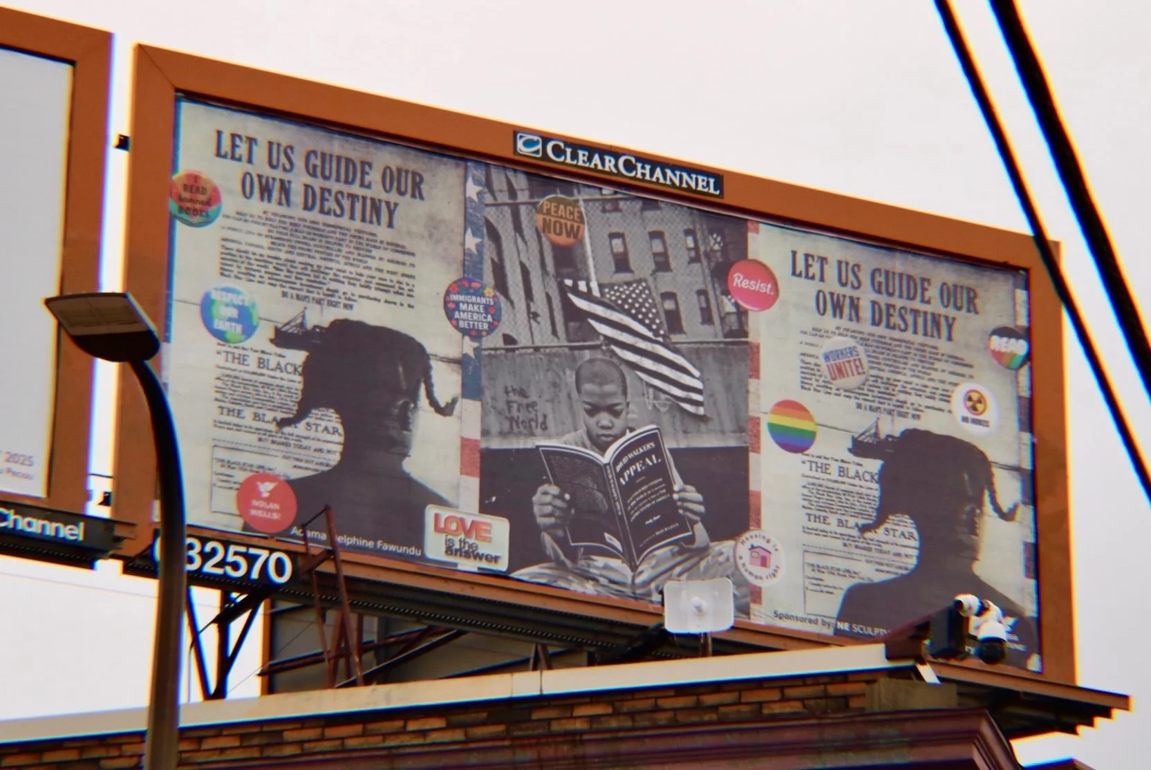 "Let Us Guide Our Own Destiny" by Adama Delphine Fawundu for Northeast Sculpture Social Justice Billboards installed in Minneapolis, Minnesota