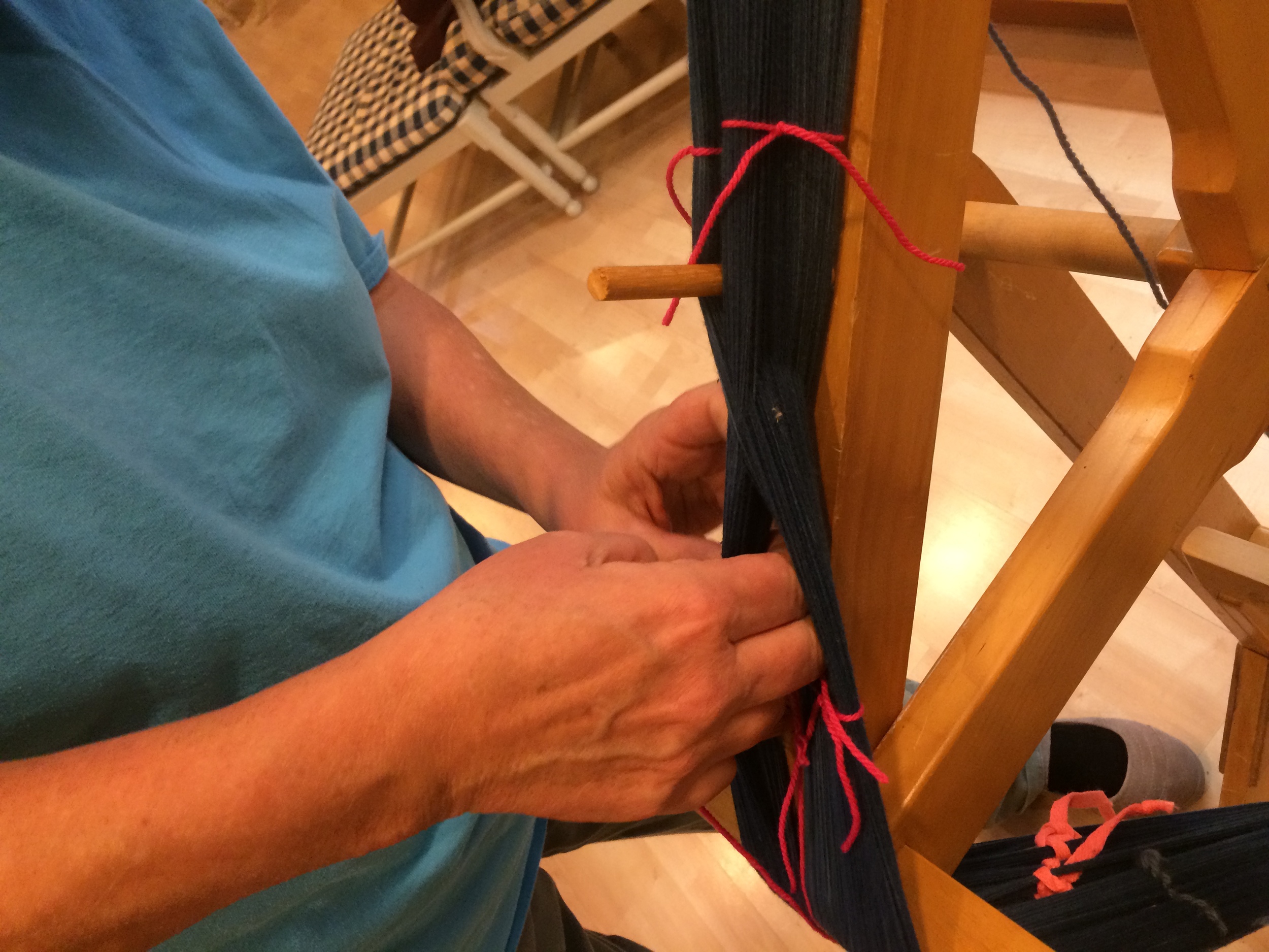 Tying off the yarns on warping frame.