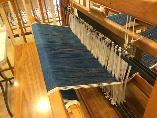 Warp yarns completely tied onto the table loom. 