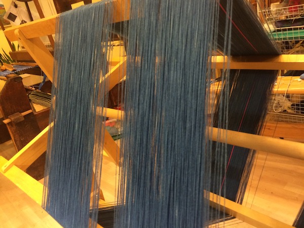 Organic cotton yarns dyed in indigo, on a warping frame. 