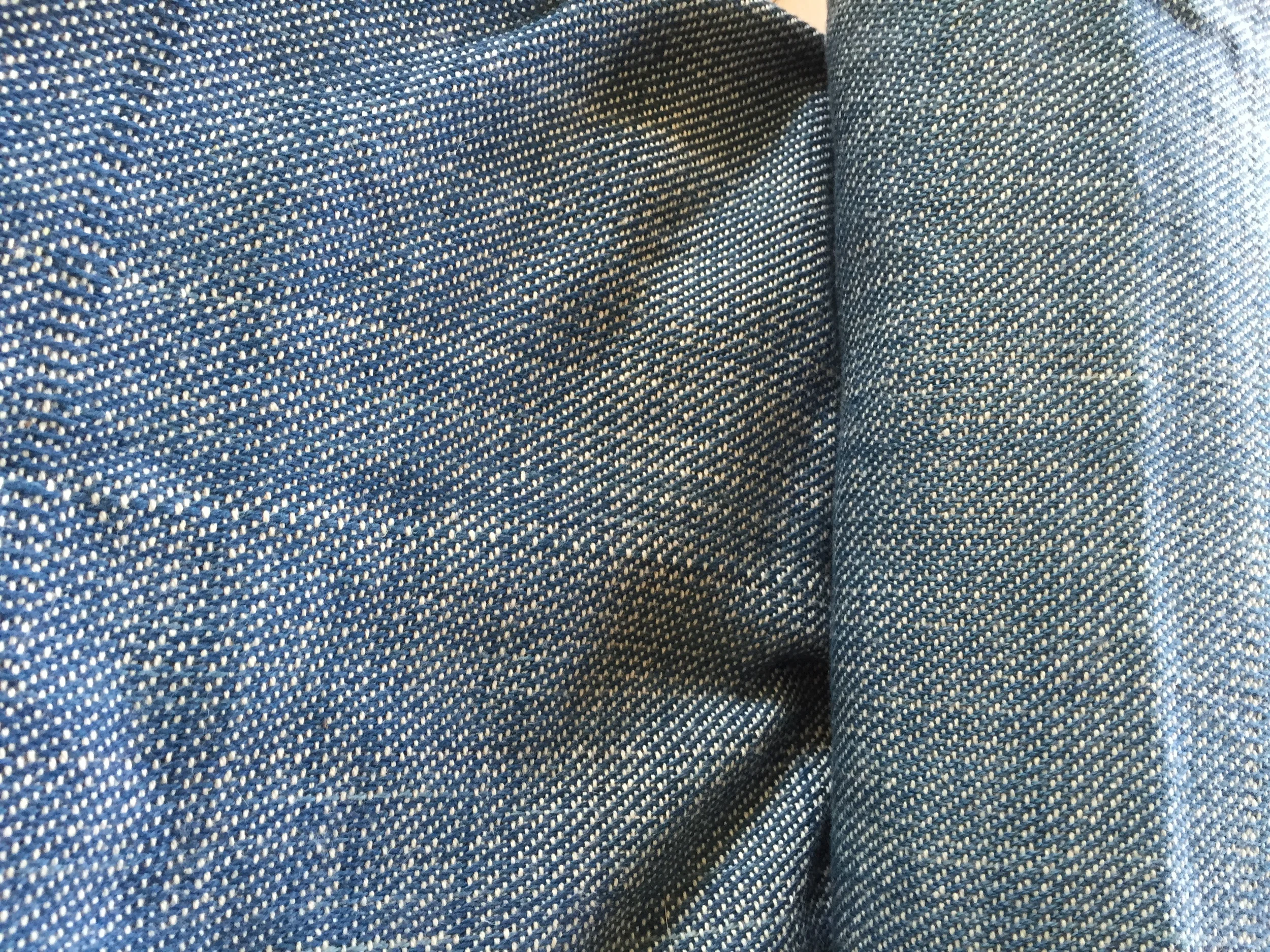 Close up on the weave structure of handwoven denim. 