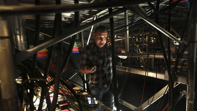 Jon Zucino works on installing fiber-optic lines for this year's Grammy Awards show at Staples Center. (Mel Melcon / Los Angeles Times)