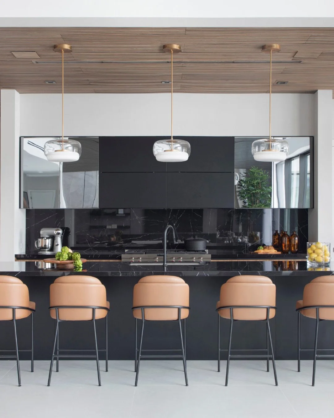 One of the things we spent the most time refining in this kitchen was the balance between warmth and contrast.

We didn&rsquo;t want the space to feel too cold or overly minimal.
The wood ceiling and cabinetry brought warmth and texture, while the da