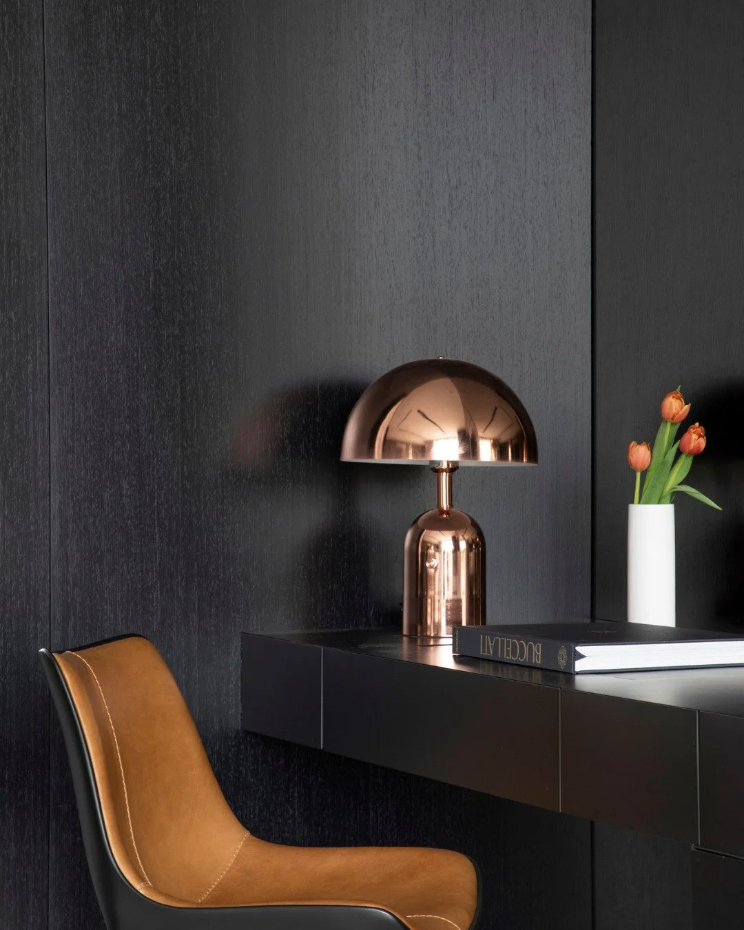 We wanted this space to feel quieter and more grounded compared to the rest of the home.

The darker palette brought a stronger mood to the room, while the warm leather chair and softer lighting kept it from feeling too heavy.

A simple corner, but o