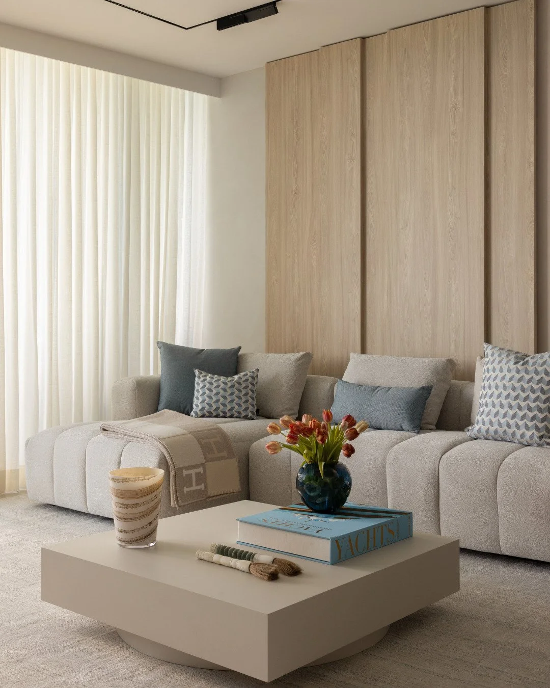 A living room with a view like this doesn't need much competing for attention 
just a few pieces with personality.
Neutral seating, soft textiles, and a favorite surfboard that turns the corner into a personal statement.
Design should always leave ro