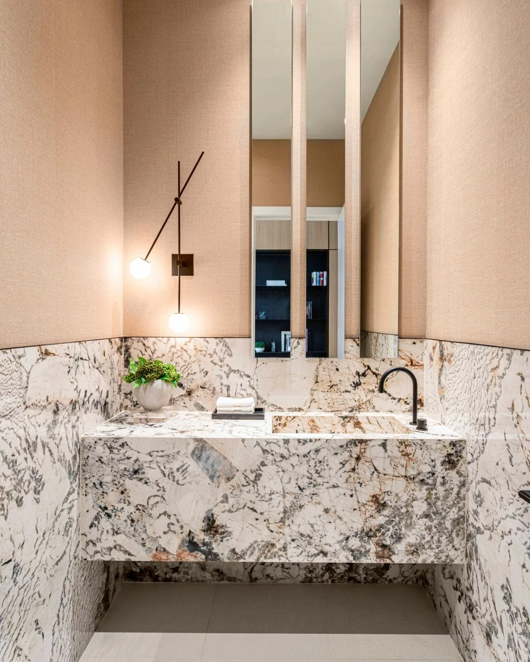 Small room. Strong choices.

In this powder room, we let the stone take over, using it across the walls and vanity to turn a small space into one of the most memorable moments in the home.
#interiordesign #luxurydesign #interiordecor