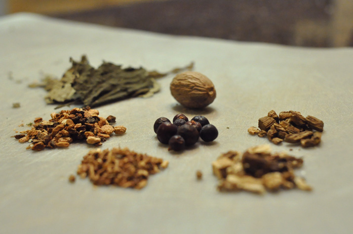 Clockwise: nutmeg, burdock, dandelion root, sasparilla, birch bark, ojasanta and juniper berries.