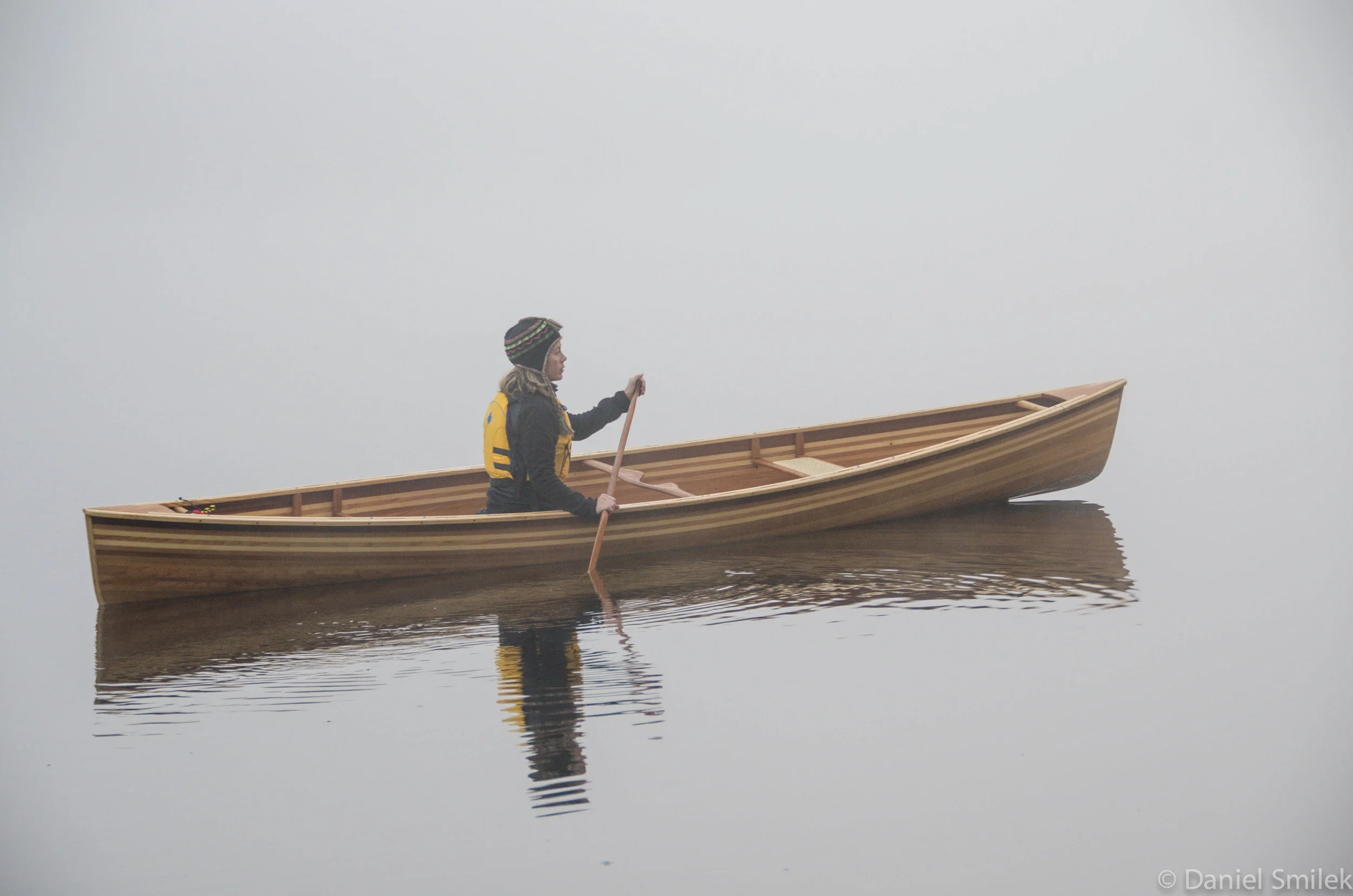 Shelley paddling the cedar strip Kipawa on a misty morning in Algonquin Park.