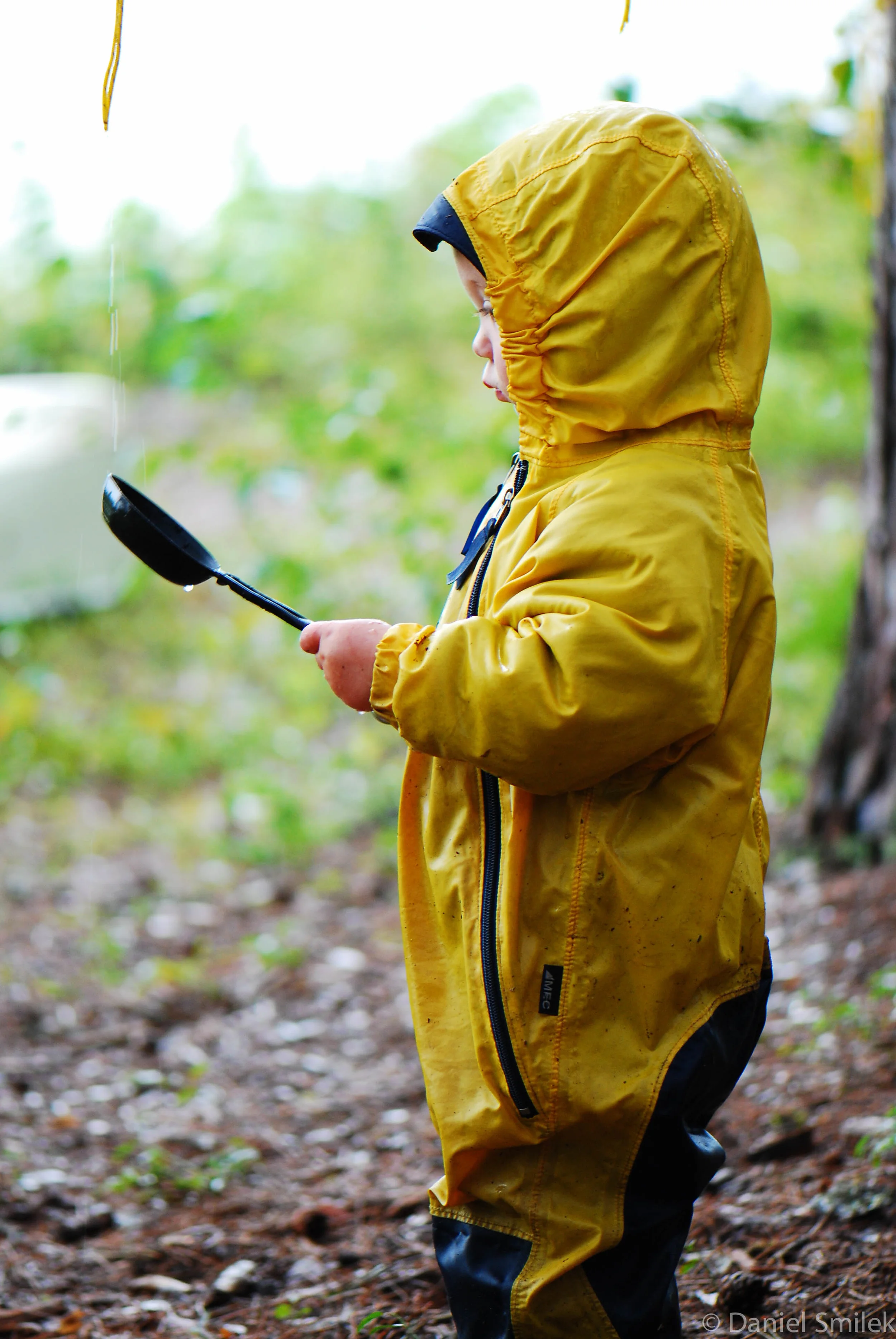 Luke at 1.5 years of age playing with water dripping from the tarp.