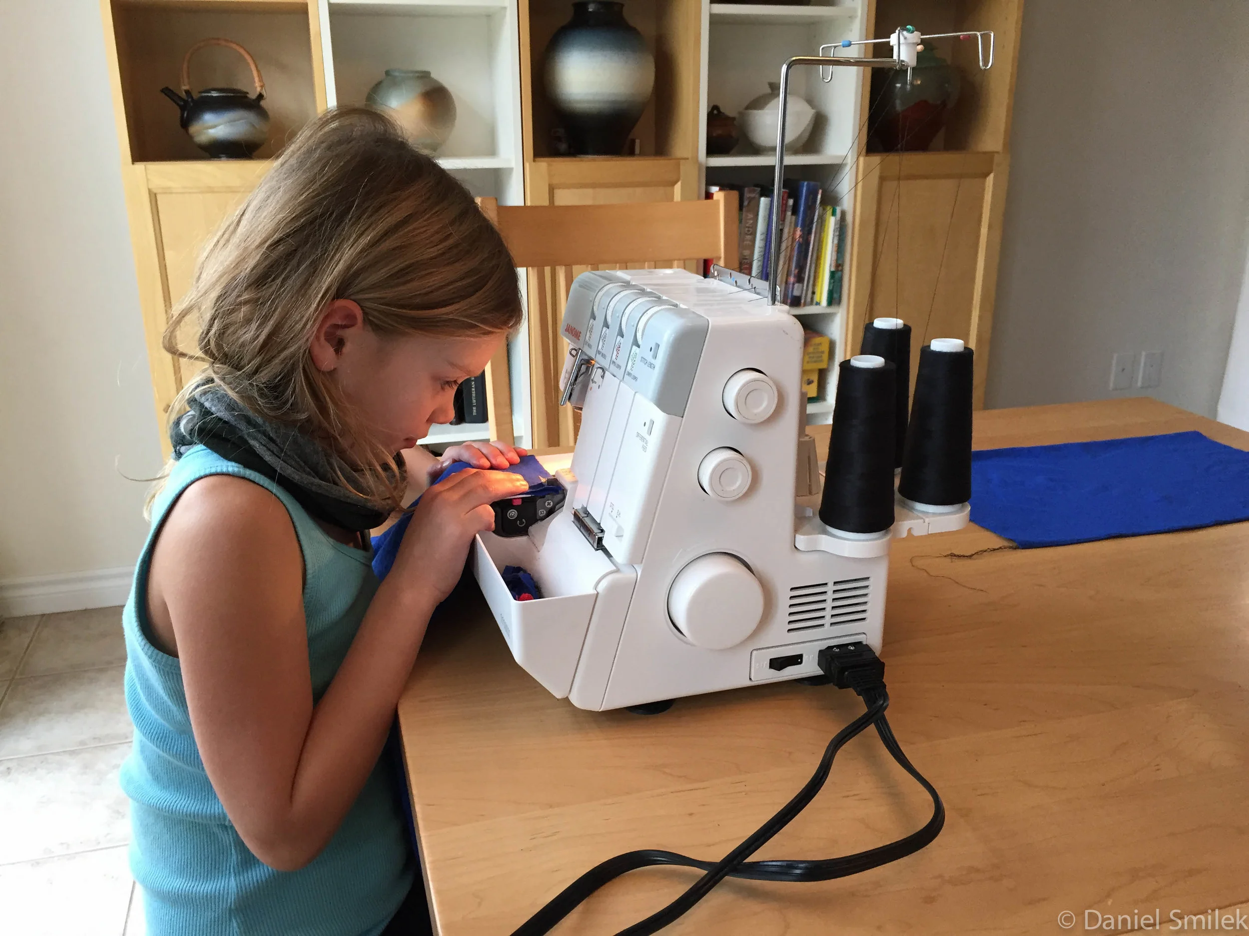 Cousin Eva sewing together her bandana on a serger.