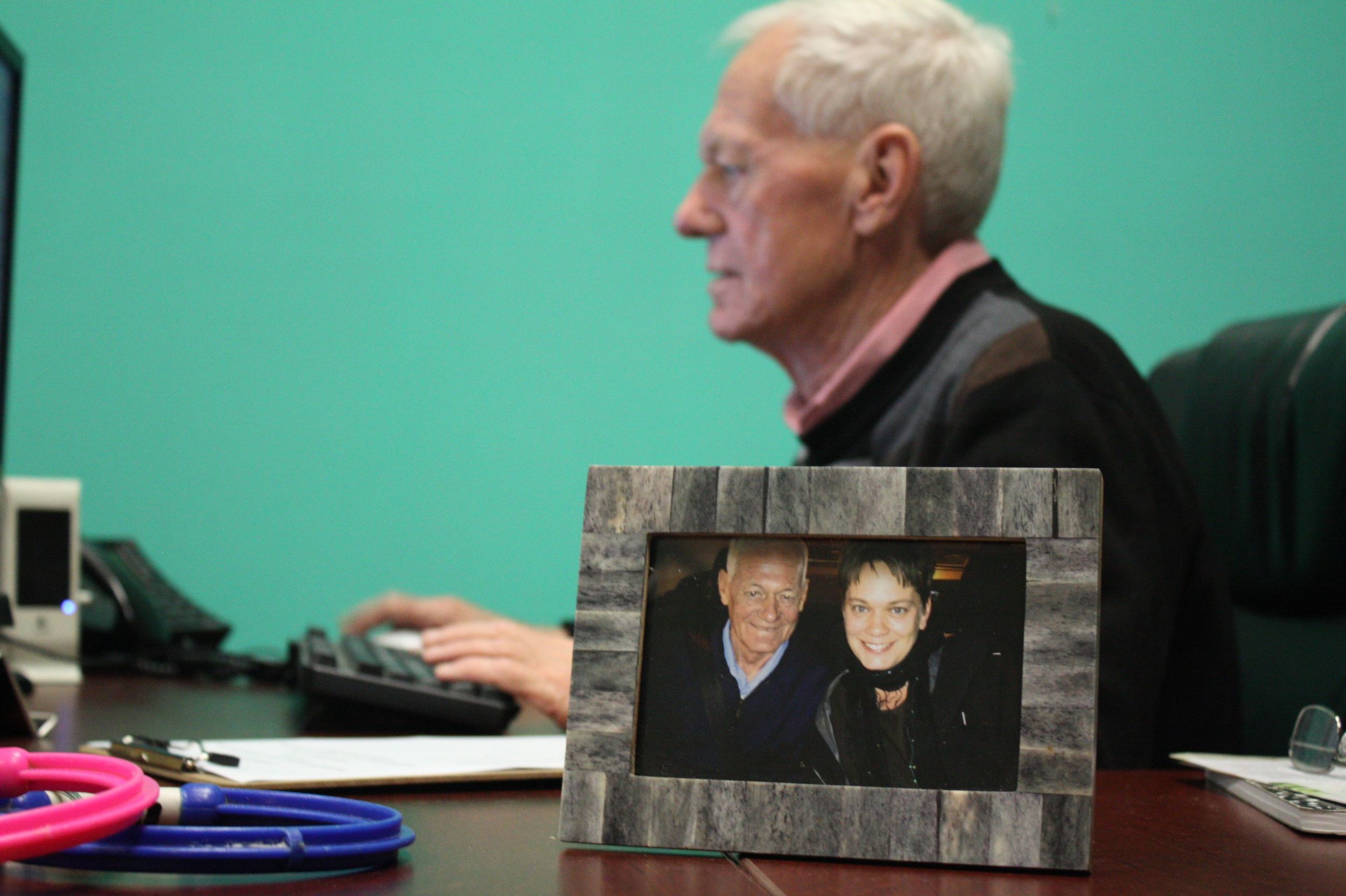 Michael working in the volunteer office, a photo of him with his daughter moments after they met for the first time. Taken from the back seat of my car in the airport parking lot. 