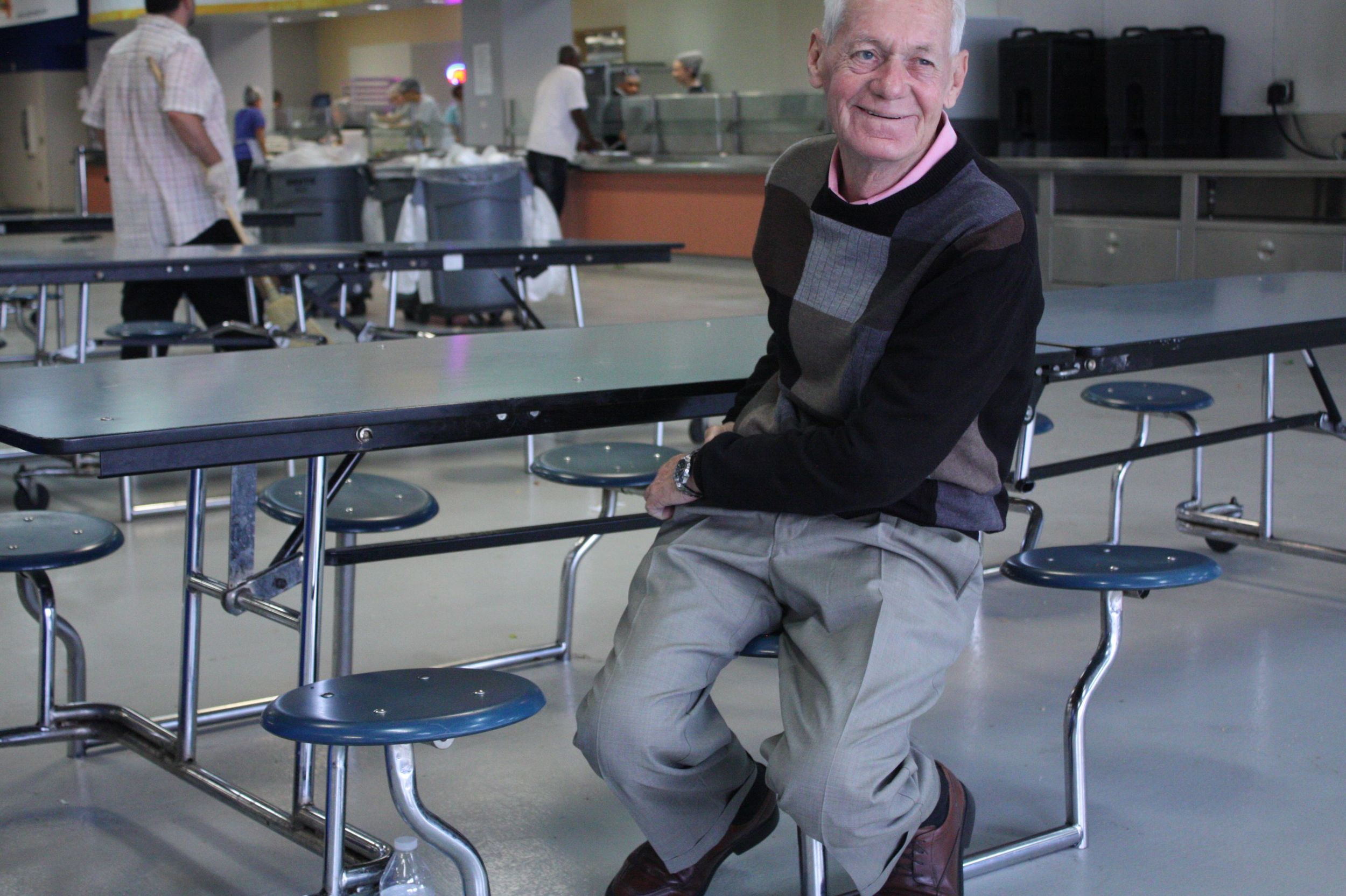 Between meal times in the cafeteria, Michael checks on volunteers whom he's been working with that week as part of his new job in the Volunteer Department. 