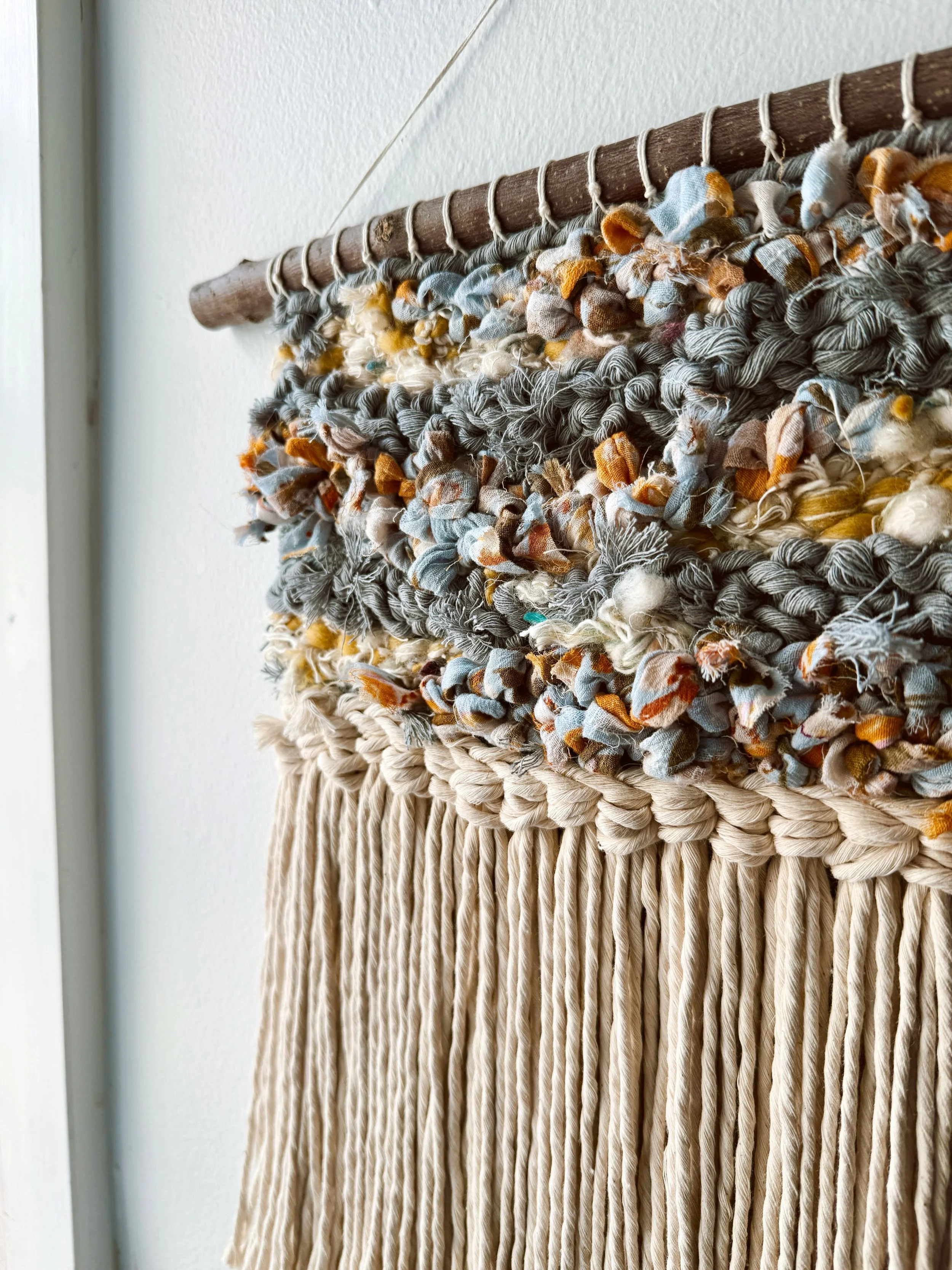 &ldquo;Sunrise in the Garden,&rdquo; handwoven with vintage floral fabric, handspun art yarn and recycled cotton cord. The branch was ethically + legally foraged in Montana, and the rings on the ends are so beautiful 🪵 (Surprisingly, this is the fir