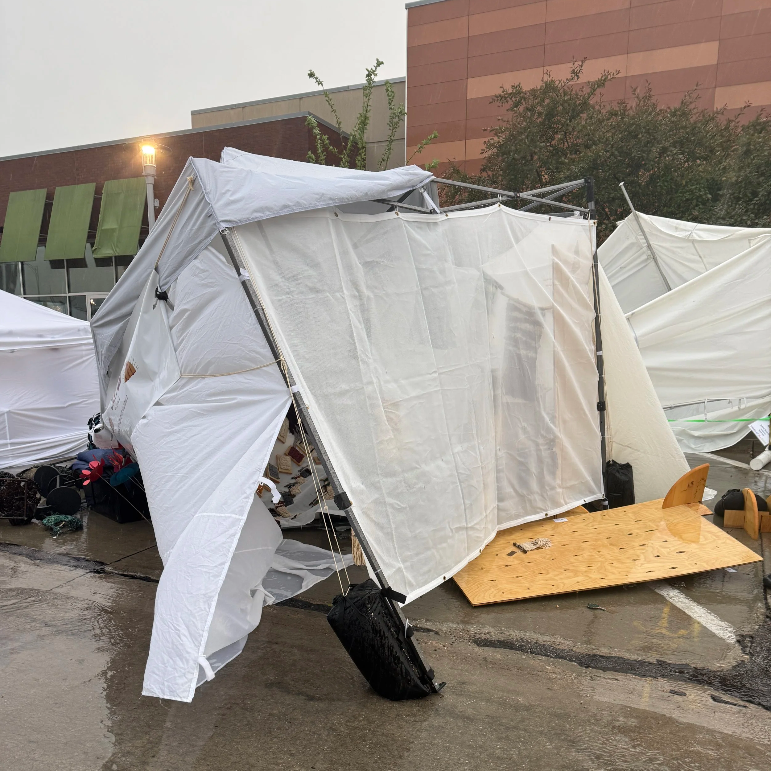 Lionheart Canyon Studio's collapsed booth after the storm at Omaha Art Fair, June 13, 2026 = Kate Laing