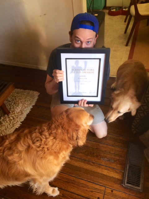 Tom, at home, with his dogs and his SAG Award certificate for "Argo."