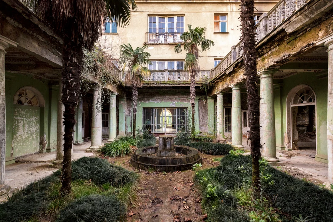Vegetation takes over a garden inside a former Sanatorium in Georgia. Image - March 2018.