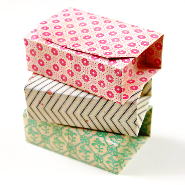 three rectangular origami boxes stacked on top of each other