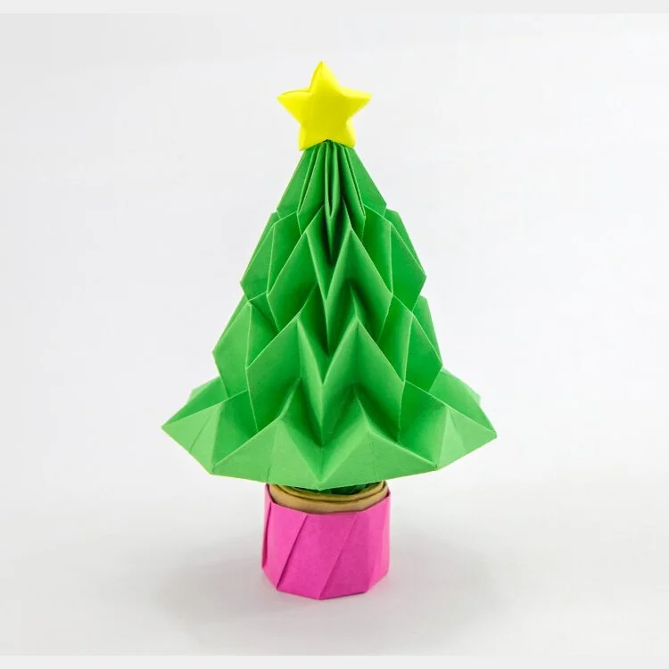 green origami christmas tree with pink trunk and yellow star on top