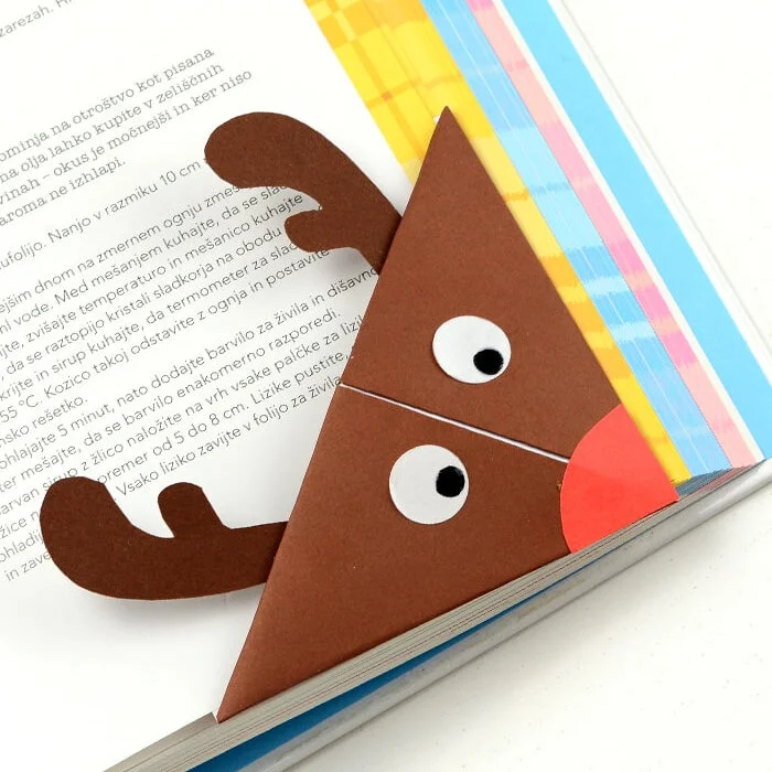 origami reindeer bookmark on corner of book