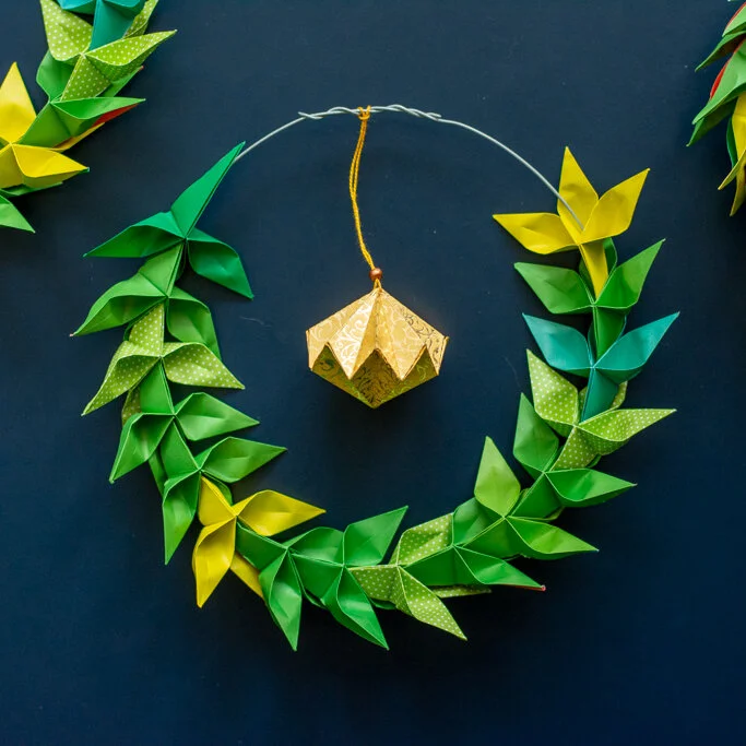 green origami leaf wreath on dark background