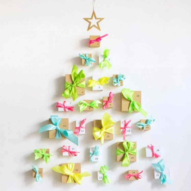 brown boxes wrapped in ribbon laid out on table in tree shape