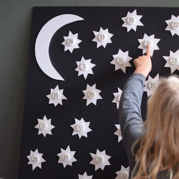 white paper stars and moon on black