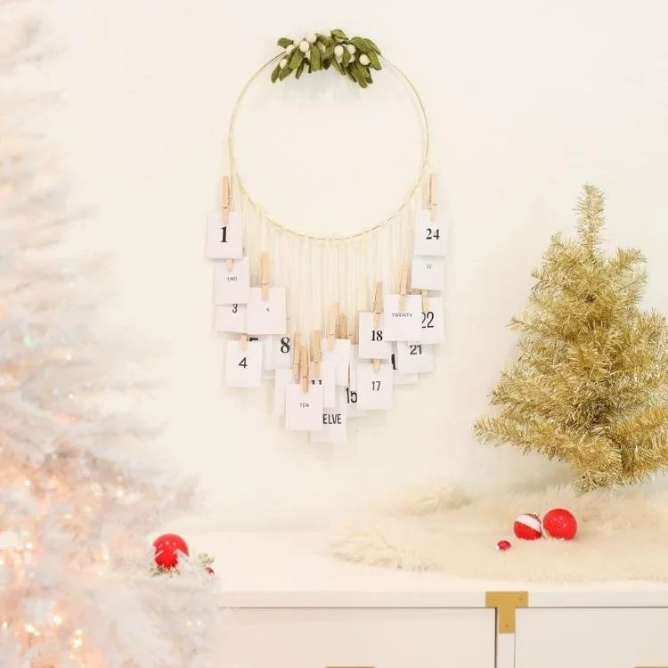 white envelopes hanging from wooden hoop