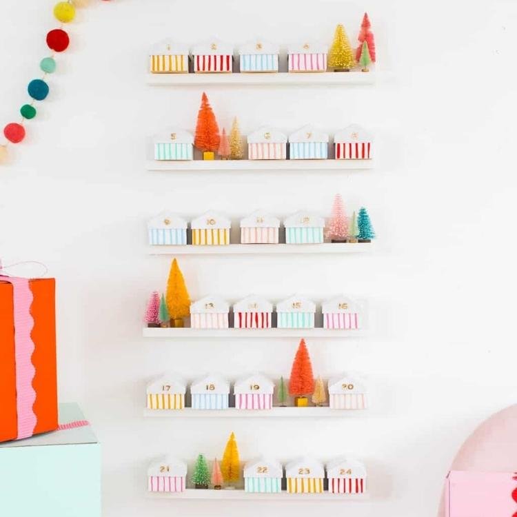 numbered boxes decorated as houses on shelves