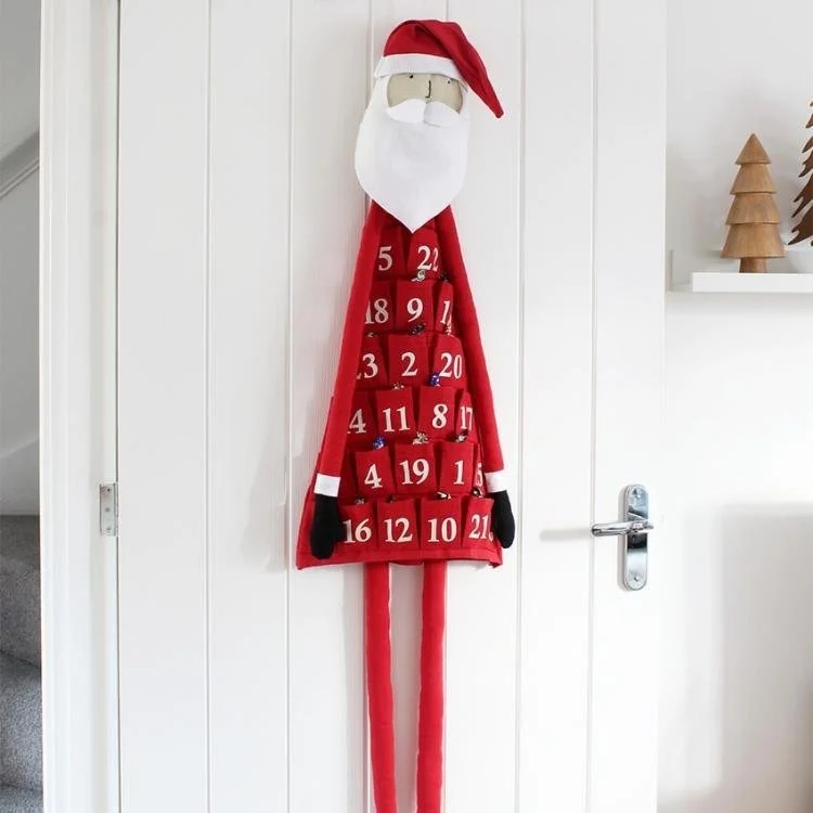 handmade red felt father christmas hanging on the back of a door