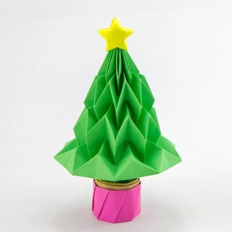 green origami christmas tree in a pink pot with a yellow star on top