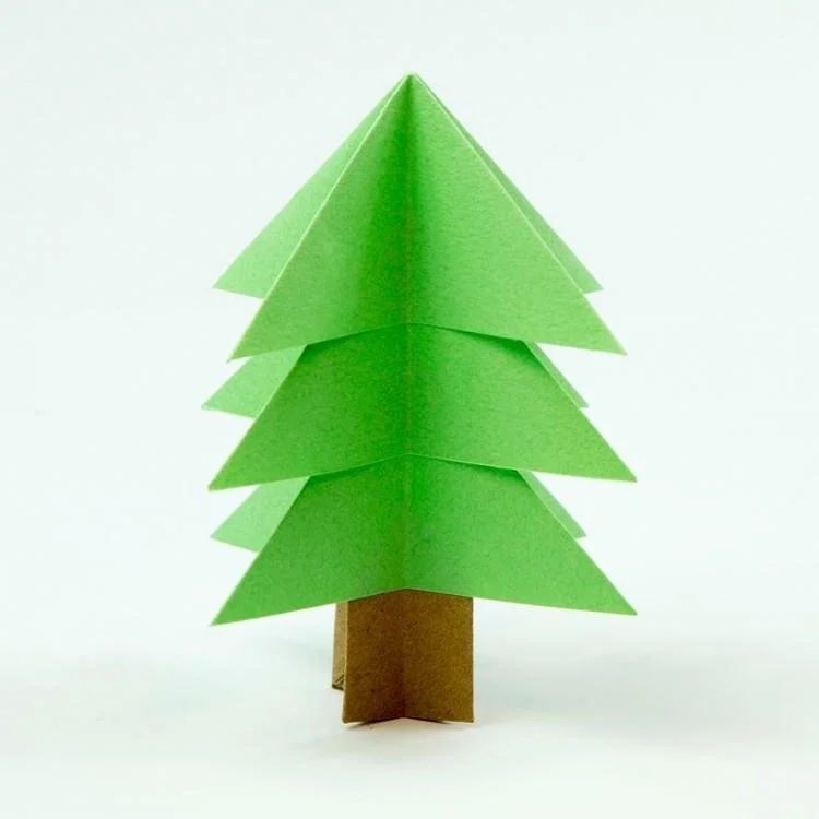 3D green  paper christmas tree with brown trunk standing up