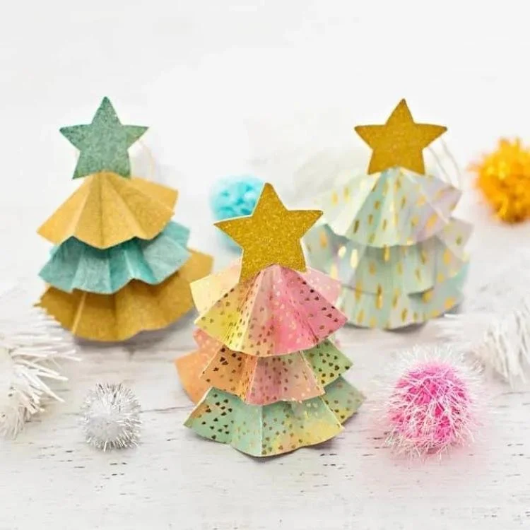 3 pastel accordion folded origami trees topped with gold stars